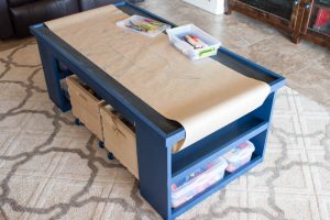 This table is perfect for keeping the kids entertained! It can be used as a train table, a Lego table, drawing, and more! Plus there's loads of storage space! It is the perfect DIY gift idea for Christmas!