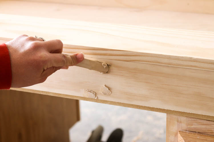 Filling nail holes with wood filler