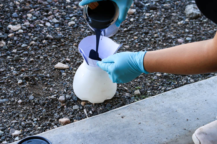 straining paint in a paint sprayer