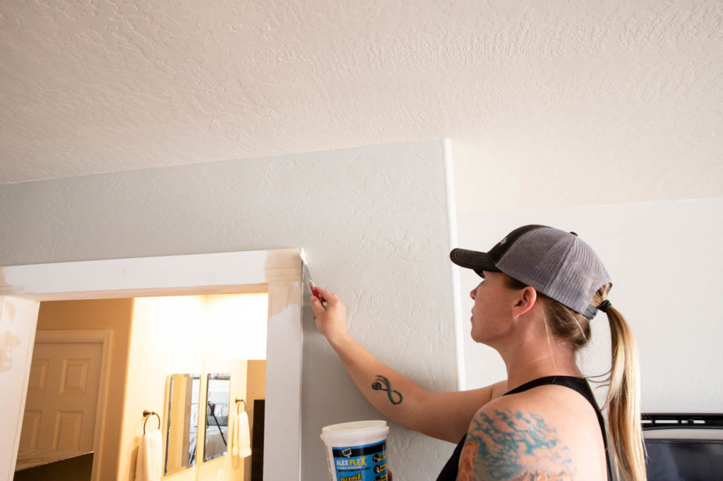 applying spackle to trim