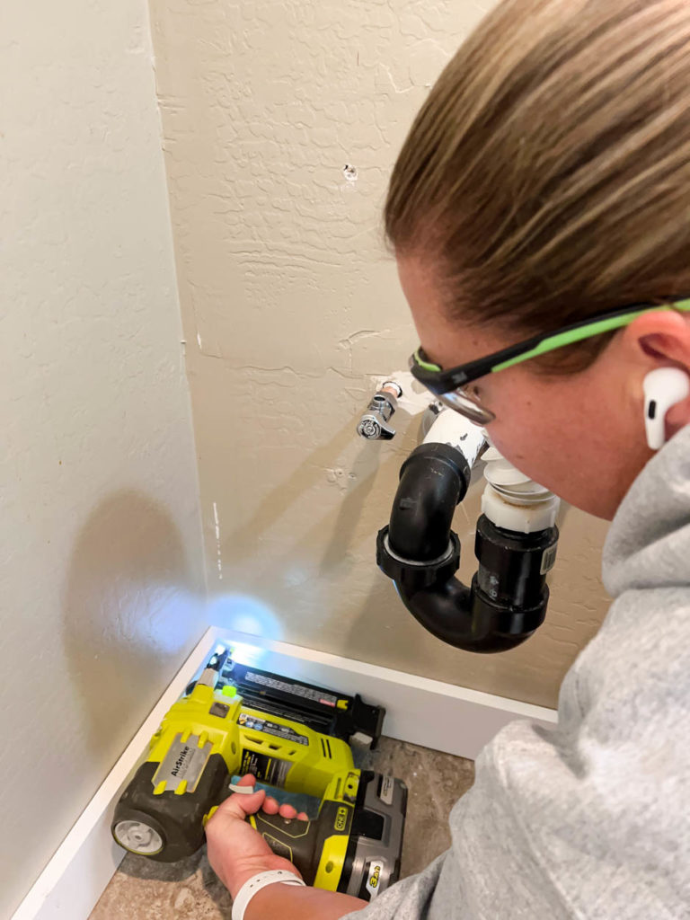 nailing baseboard trim in place