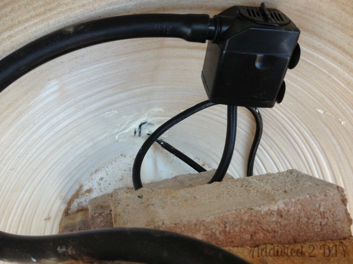 Submersible water pump and tubing installed inside bottom pot for DIY water fountain build