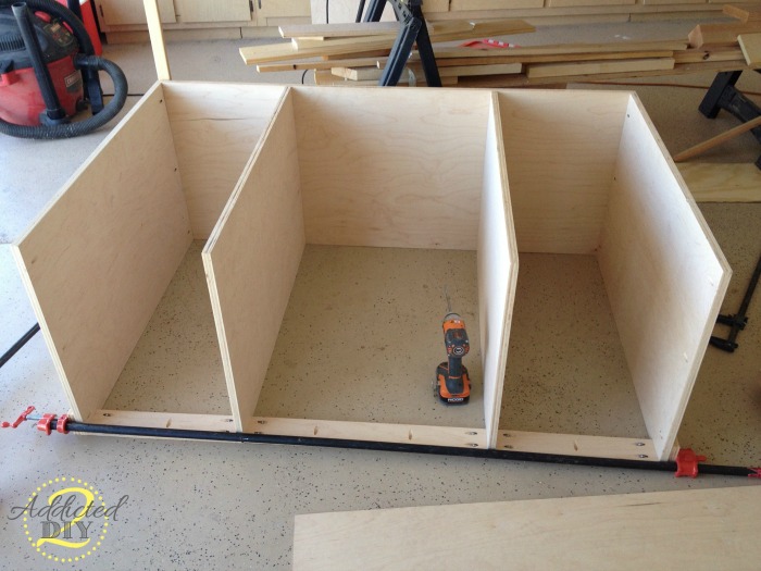 Assembling the plywood cabinet box for a DIY kitchen island in a garage workshop