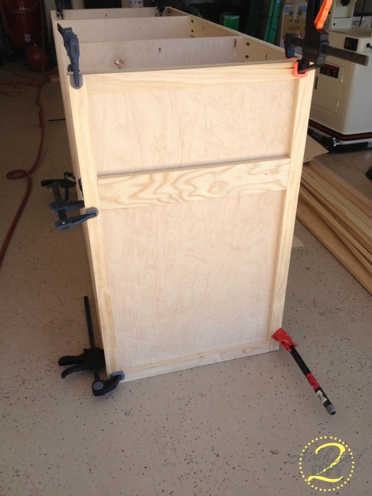 Clamped side panel frame attached to the kitchen island base during the build process
