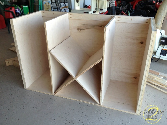 Decorative X shelf installed in the center storage section of a DIY kitchen island