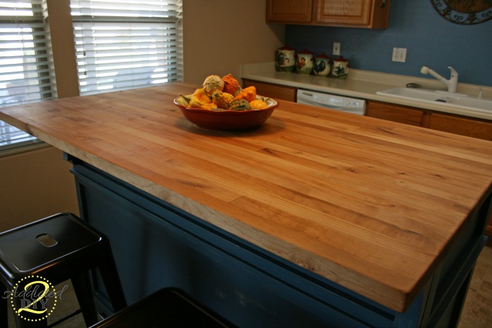 Finished DIY butcher block countertop installed on kitchen island with warm wood tones and smooth finish
