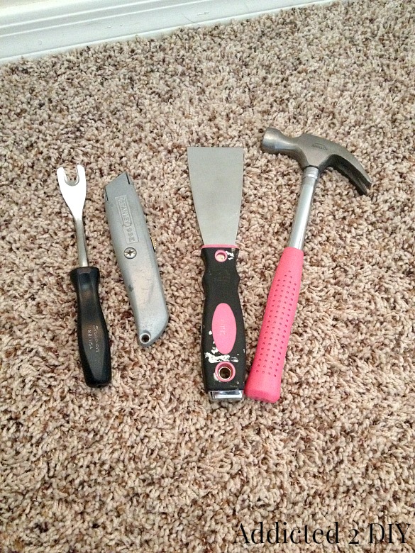Tools needed to remove baseboards including pry tool, utility knife, putty knife, and hammer