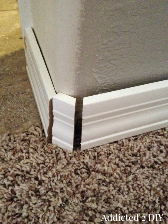 Mitered baseboard corner pieces showing angled cuts for rounded wall corner