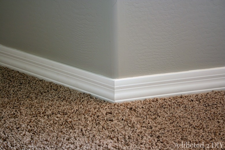 Finished baseboard installation with clean corner and seamless trim detail