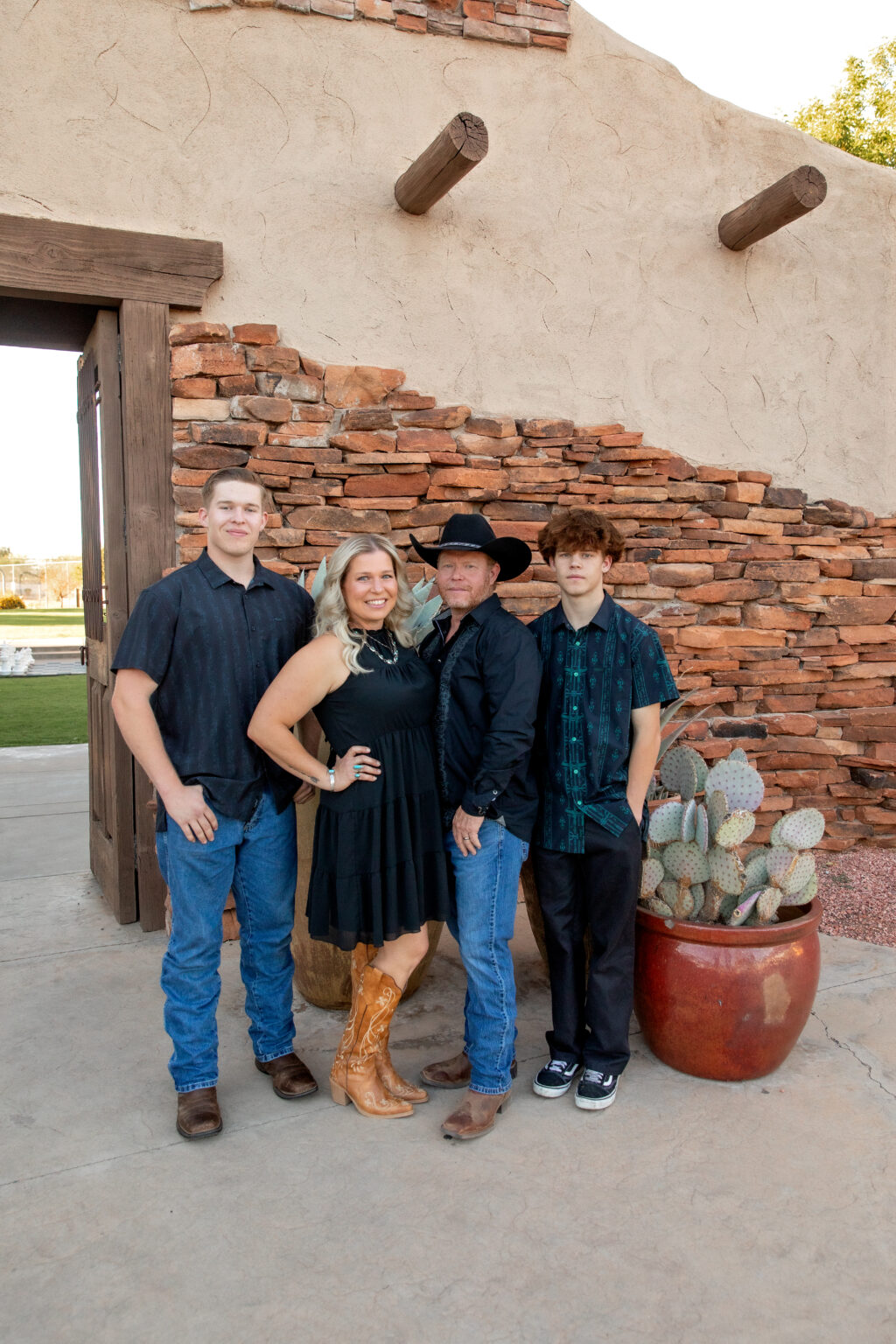 photo of a family of four standing in front of the entrance to an outdoor space