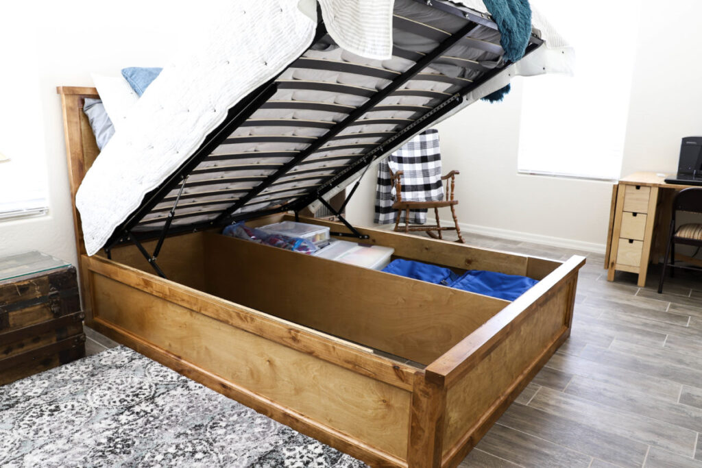 Queen size storage bed with lift-up platform open to reveal hidden under-bed storage