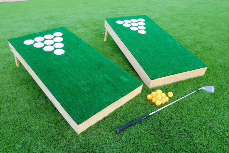 Finished DIY chip shot golf game boards set up on grass with golf balls and club