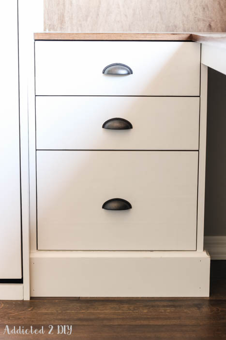 White cabinet drawers with black cup pulls