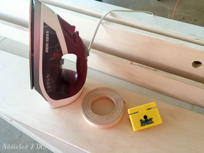 Applying edge banding to plywood using iron and trimming tool for clean finish