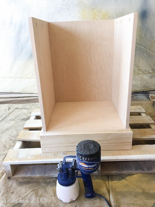 Cabinet box being spray painted white