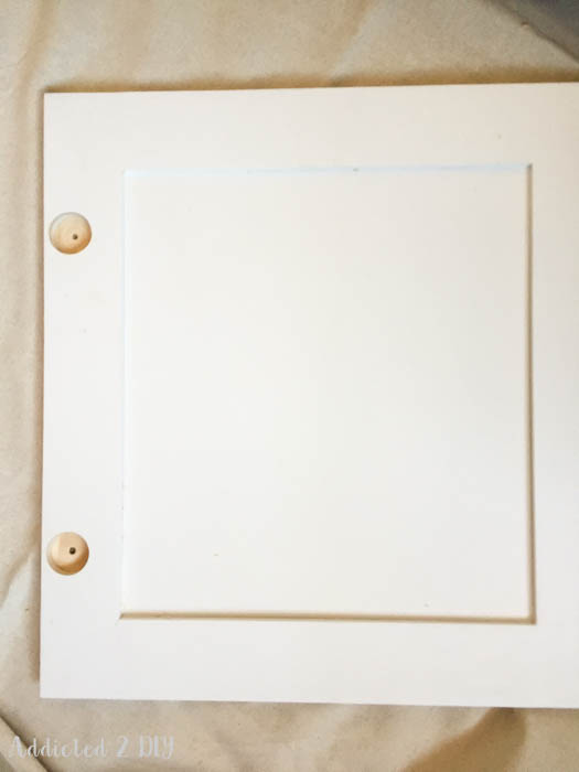 Finished cabinet door painted white