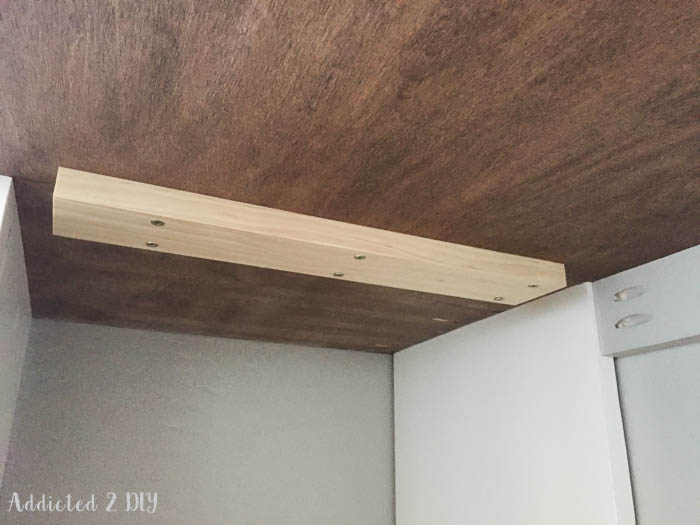 Wooden support cleat installed under desk
