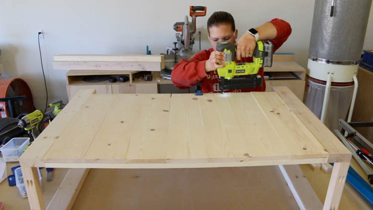 Using brad nailer to attach 1x6 boards to back of farmhouse console table base