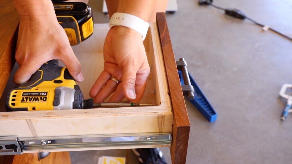 Securing wooden drawer faces to drawer boxes from inside using a DeWalt drill
