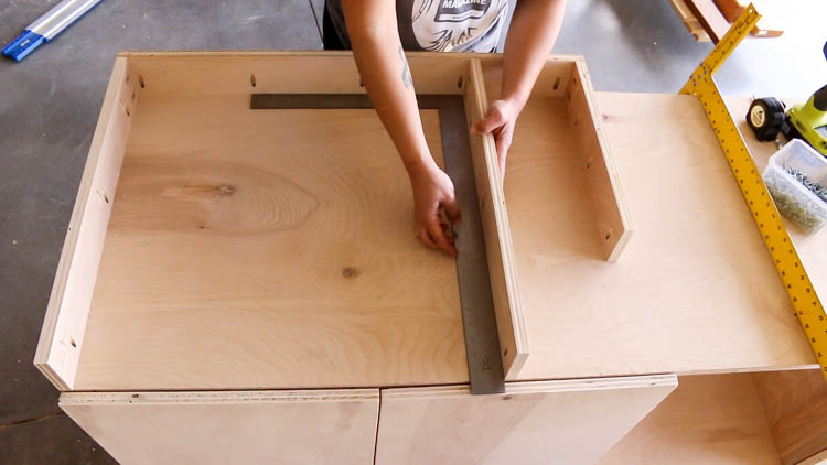 Measuring and positioning the table top frame pieces on a DIY miter saw bench to align flush with the saw base