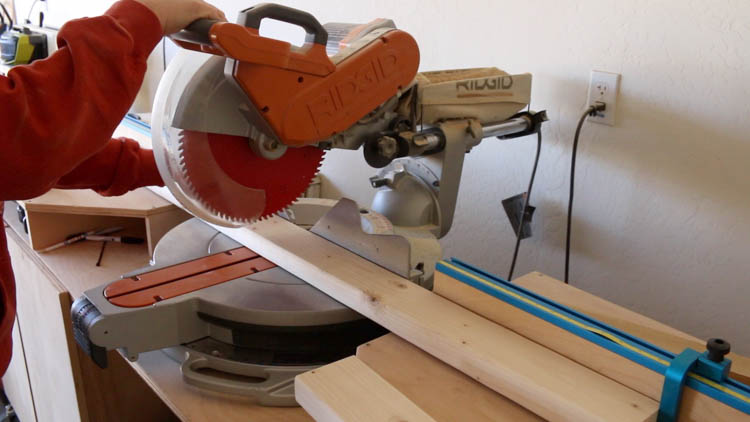 Cutting lumber to size with miter saw for DIY farmhouse console table build