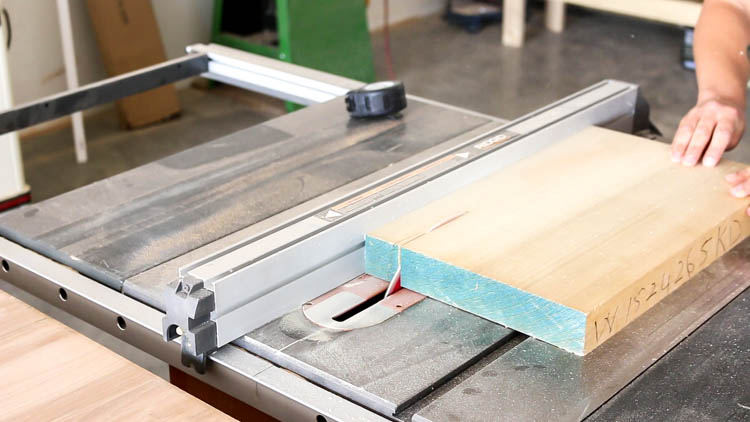 Ripping a poplar board into 2x2 sticks on a table saw for DIY rustic dresser frame construction