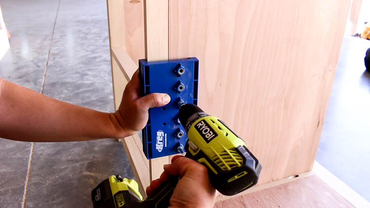 Drilling shelf pin holes in cabinet side panel using a Kreg shelf pin jig and Ryobi drill