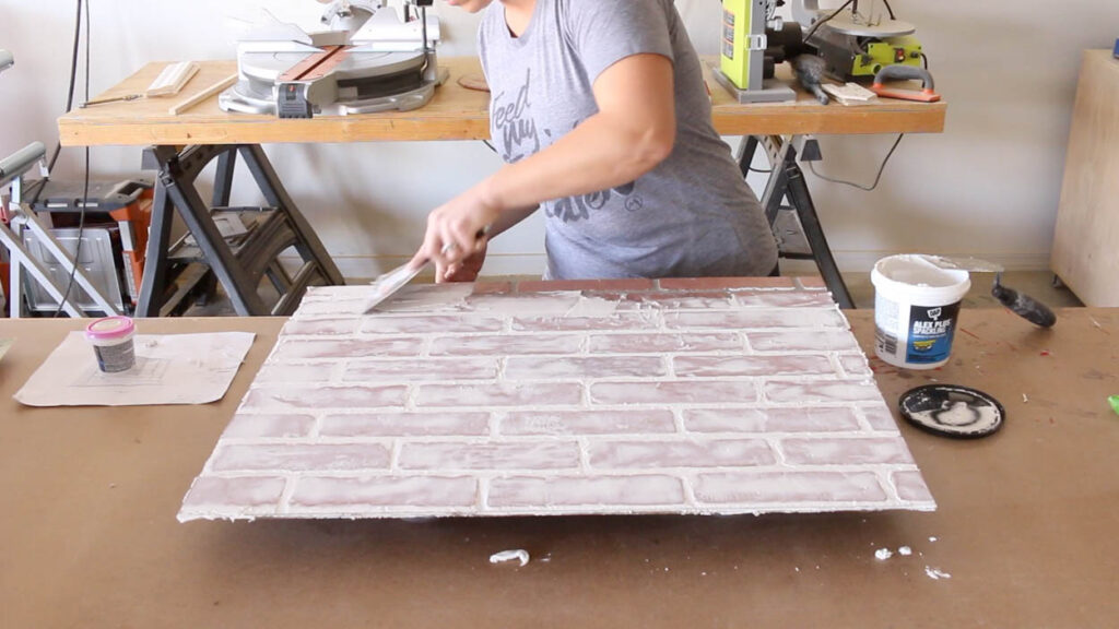 applying German schmear technique to faux brick panel using spackling