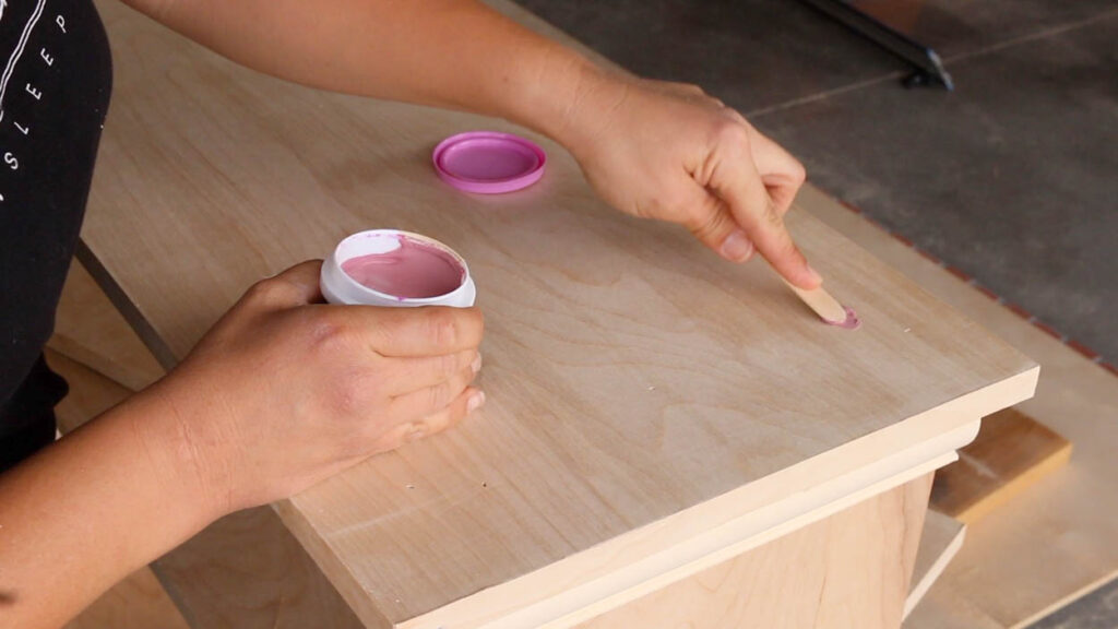 filling nail holes and wood imperfections before painting the faux fireplace