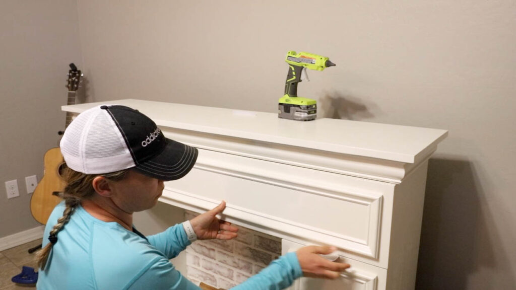 installing and securing the drawer inside the finished faux fireplace