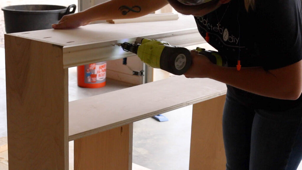 securing the fireplace mantel trim using a brad nailer