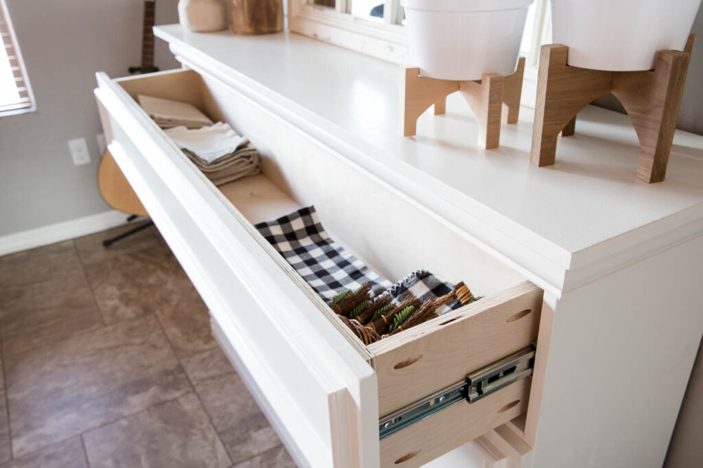 pull-out drawer storage inside DIY faux fireplace showing hidden storage space
