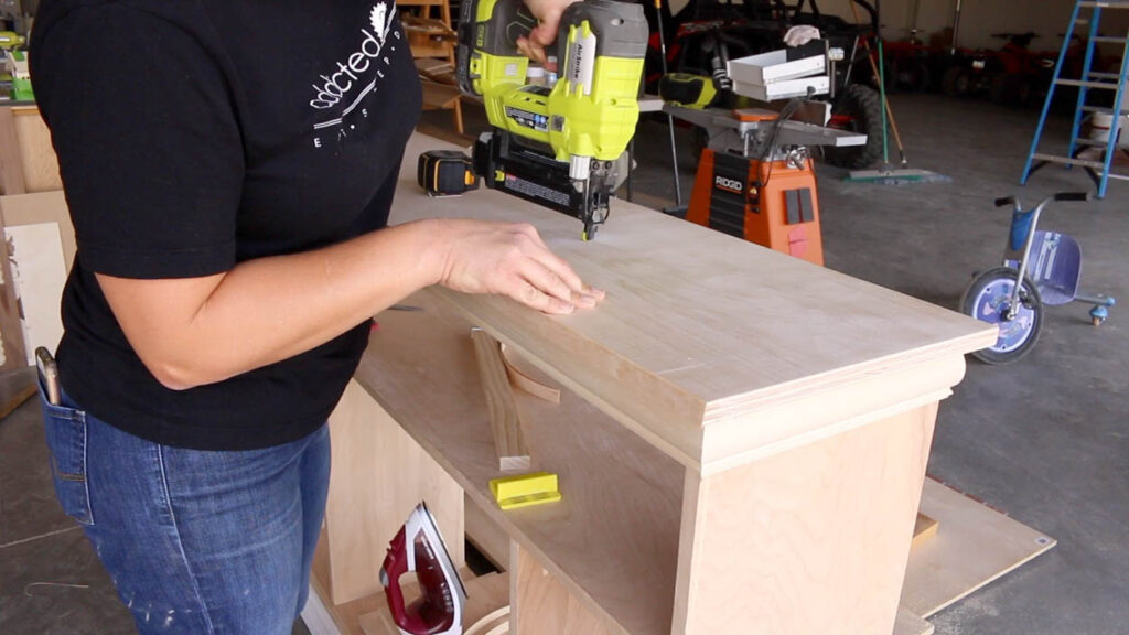 attaching the top of the faux fireplace to the carcass with a brad nailer