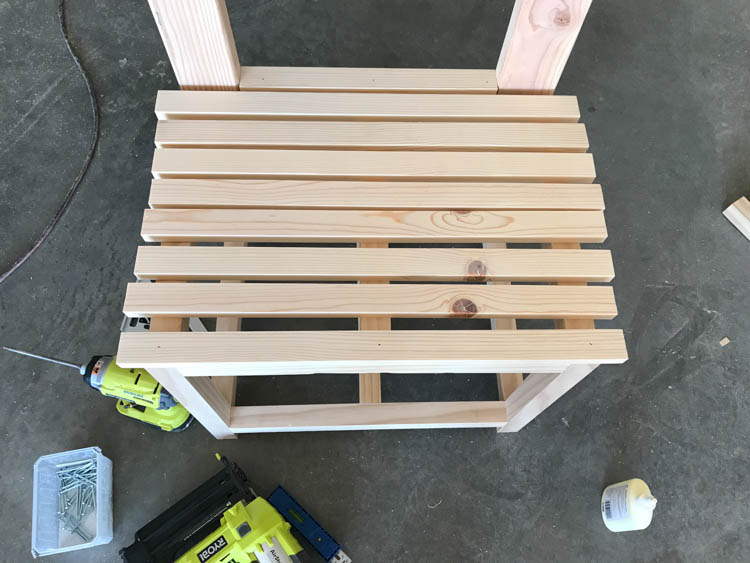 1x2 bench seat slats spaced and laid out on DIY hall tree frame