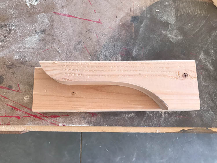 Finished shelf bracket with decorative curved radius cut and sanded smooth
