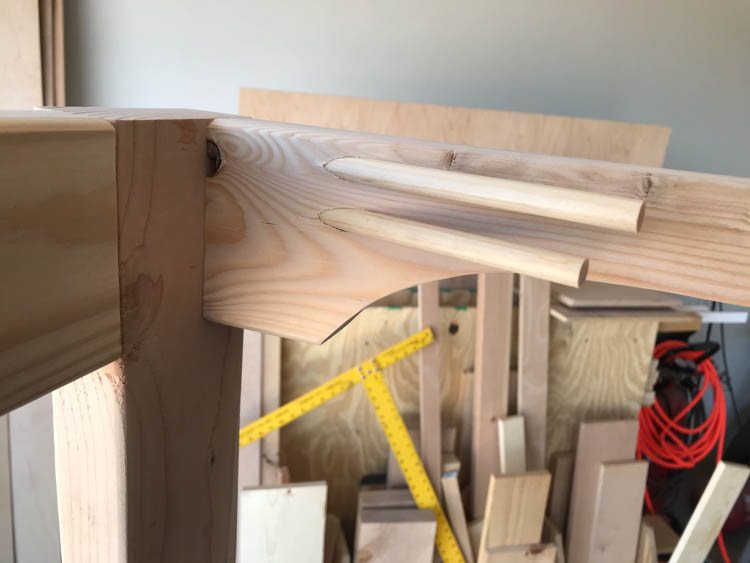 Shelf bracket pocket holes filled with wood dowels before sanding