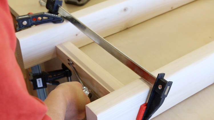 Driving pocket screws to join side stretchers to legs of farmhouse console table frame