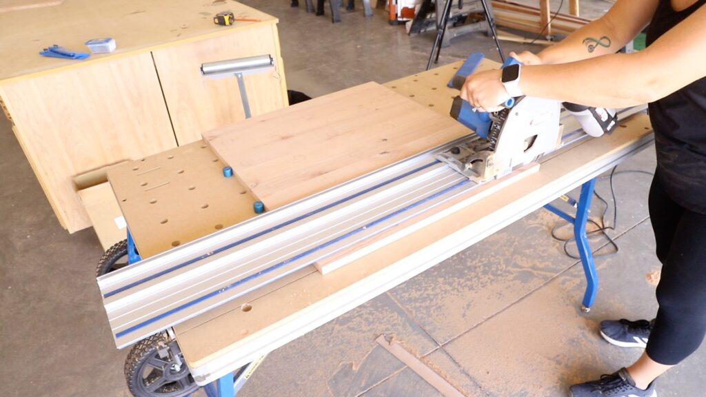 Trimming the front edge of a wood side panel to size using a Kreg Adaptive Cutting System track saw
