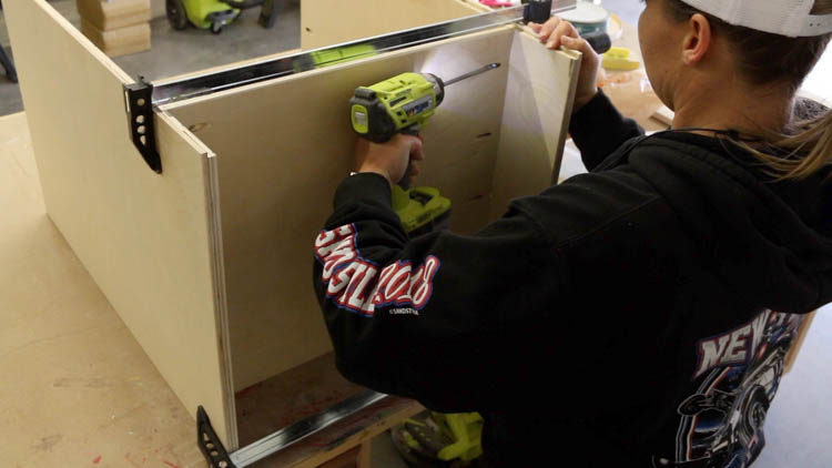securing the base of the printer cabinet to the sides with pocket hole joinery