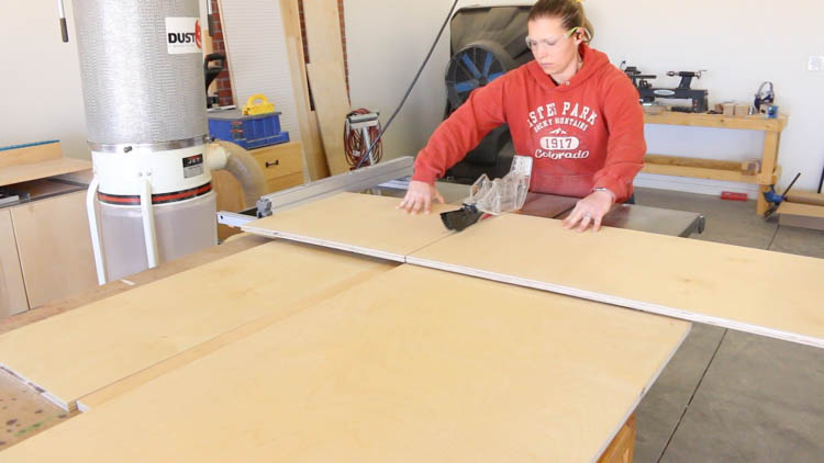 Cross-cutting a full sheet of plywood on a table saw to size cabinet panels for a DIY printer cabinet build