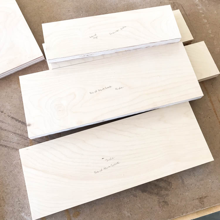 Cut and labeled plywood pieces for assembling a modern DIY nightstand