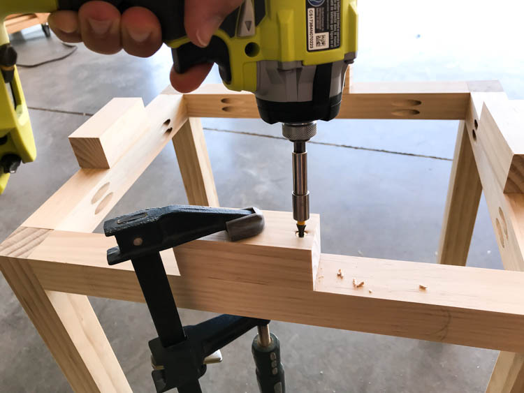 Attaching support spacers to create the faux floating top look on the nightstand