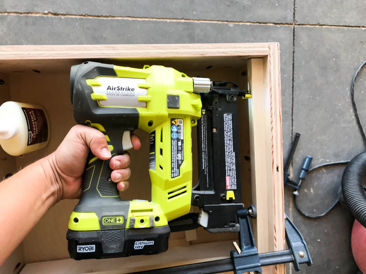 Attaching wood supports inside the nightstand for the pull-out tray