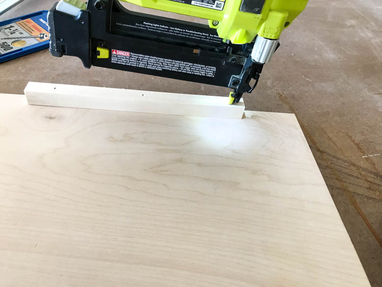 Nailing a stop to the back edge of the pull out tray on the nightstand