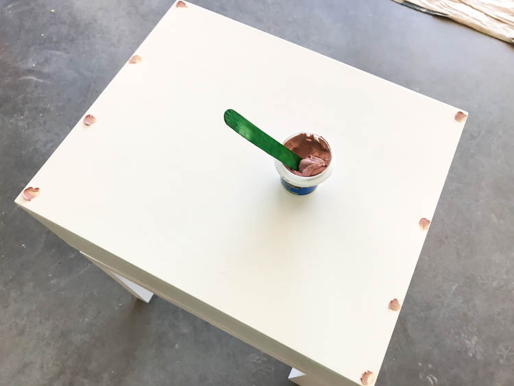 nail holes being filled in the nightstand top