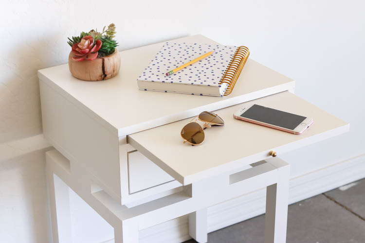 Pull-out tray extended from a modern DIY nightstand holding sunglasses and a phone
