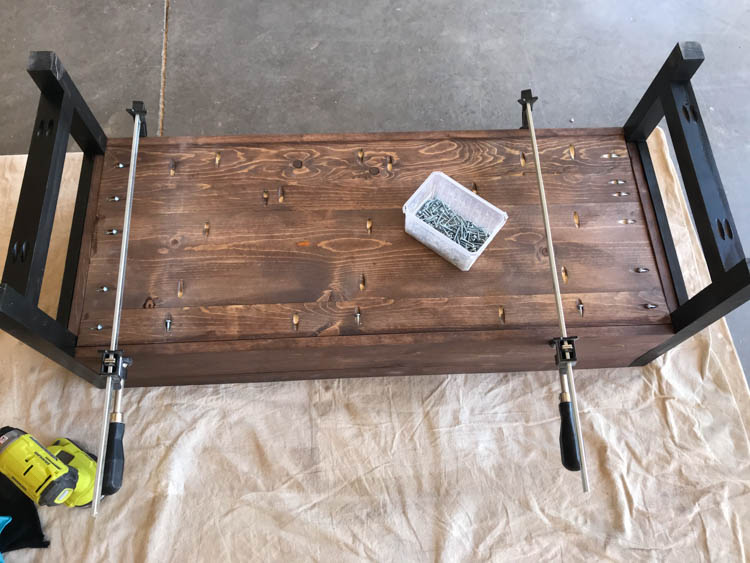 Bottom panel attached to upside down DIY storage bench frame using pocket screws