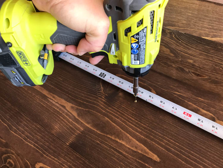measuring and marking the location of the legs from the inside of the bench and attaching with screws