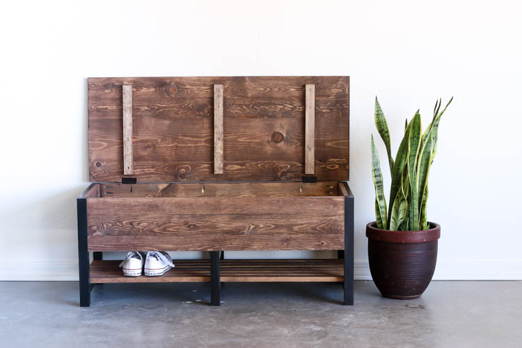 DIY storage bench with lid open showing hidden blanket storage compartment