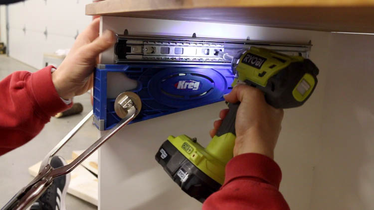 Using a Kreg drawer slide jig and two Ryobi drills to install drawer slides inside a DIY cabinet